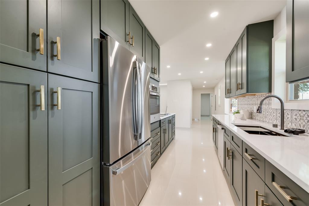 3106 Sharpview Lane Dallas, TX 75228 - Photo 9 of 33 a kitchen with stainless steel appliances a refrigerator and a sink
