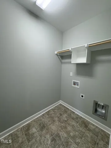 an empty room with a window and a ceiling fan