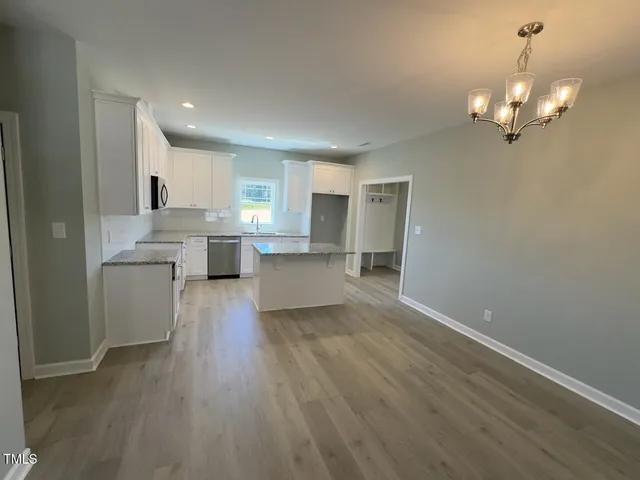 a view of a kitchen with a sink a refrigerator and window