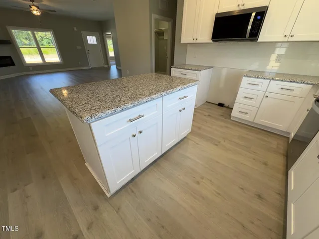 a kitchen with sink and mirror