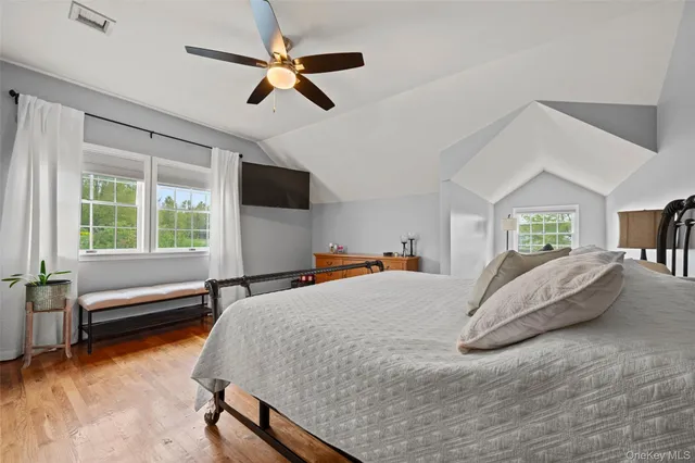 a bedroom with a bed gym equipment and a large window