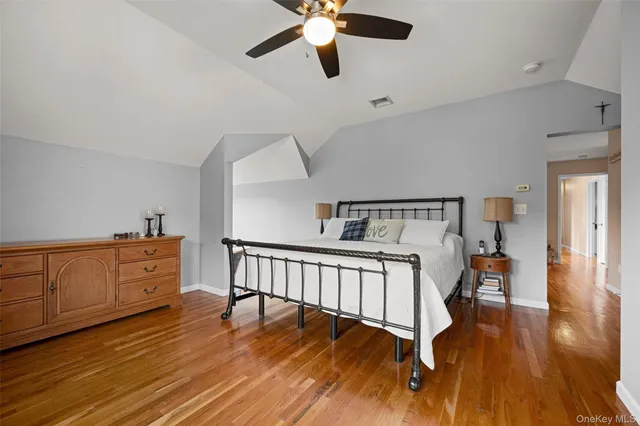 a bedroom with furniture and wooden floor