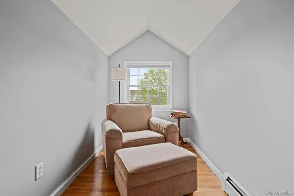 a bedroom with a bed gym equipment and a large window