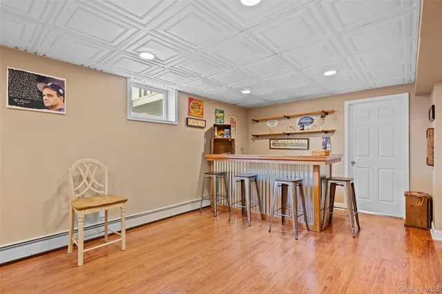 a living room with furniture a wooden floor and next to a window