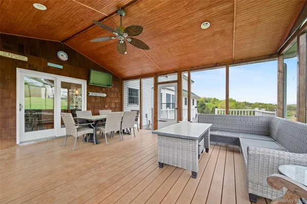 a view of a balcony with wooden floor
