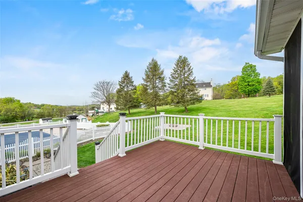 a view of a deck with a big yard and potted plants