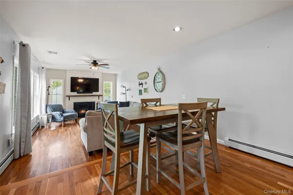 a kitchen with kitchen island granite countertop a sink a center island a stove and a wooden floors