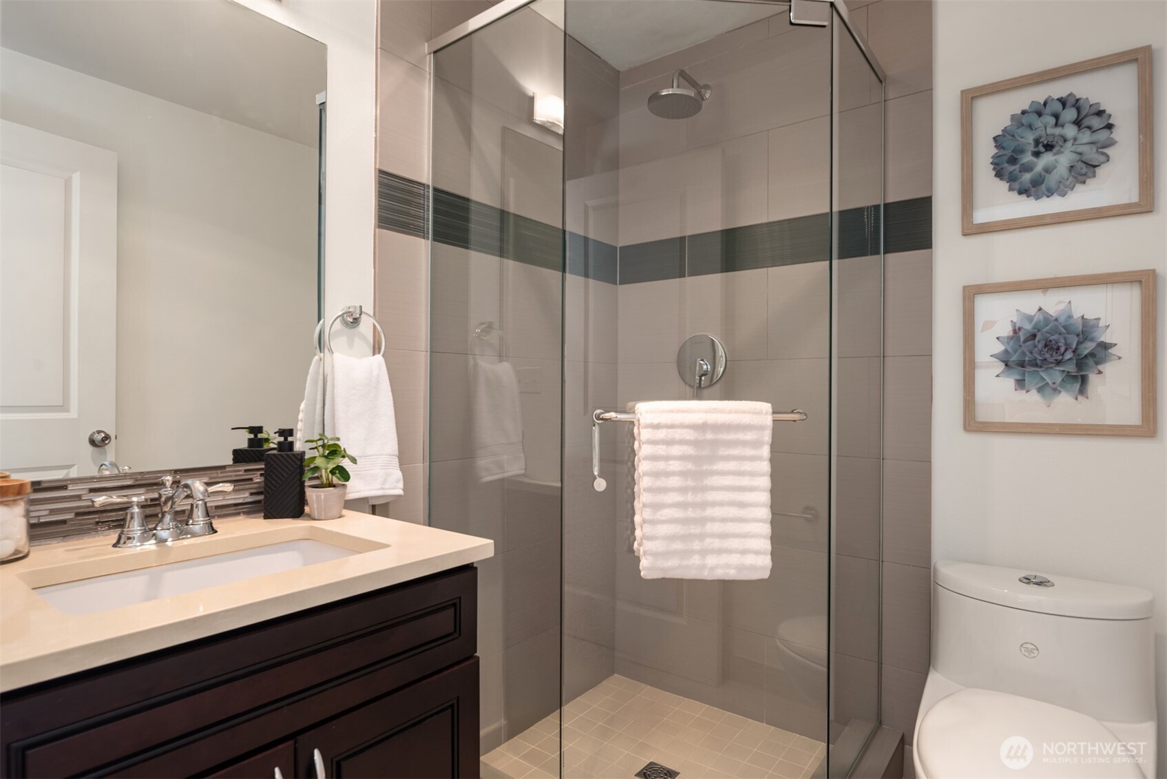 3302 West Government Way, Unit A Seattle, WA 98199 - Photo 26 of 32 a bathroom with a sink toilet a mirror and shower