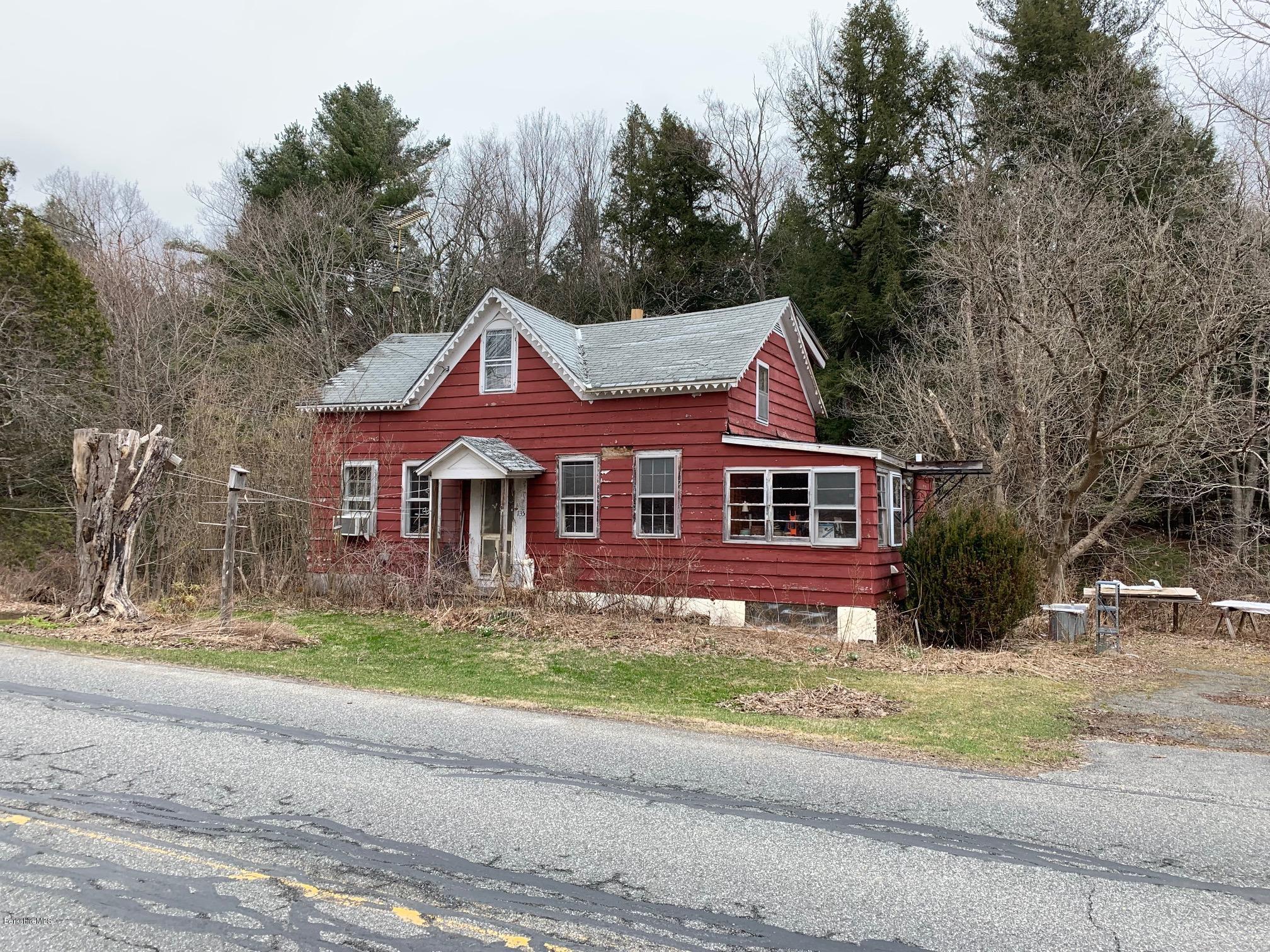 135 Main Road Tyringham, MA 01264 - Photo 1 of 8 a front view of a house with a yard
