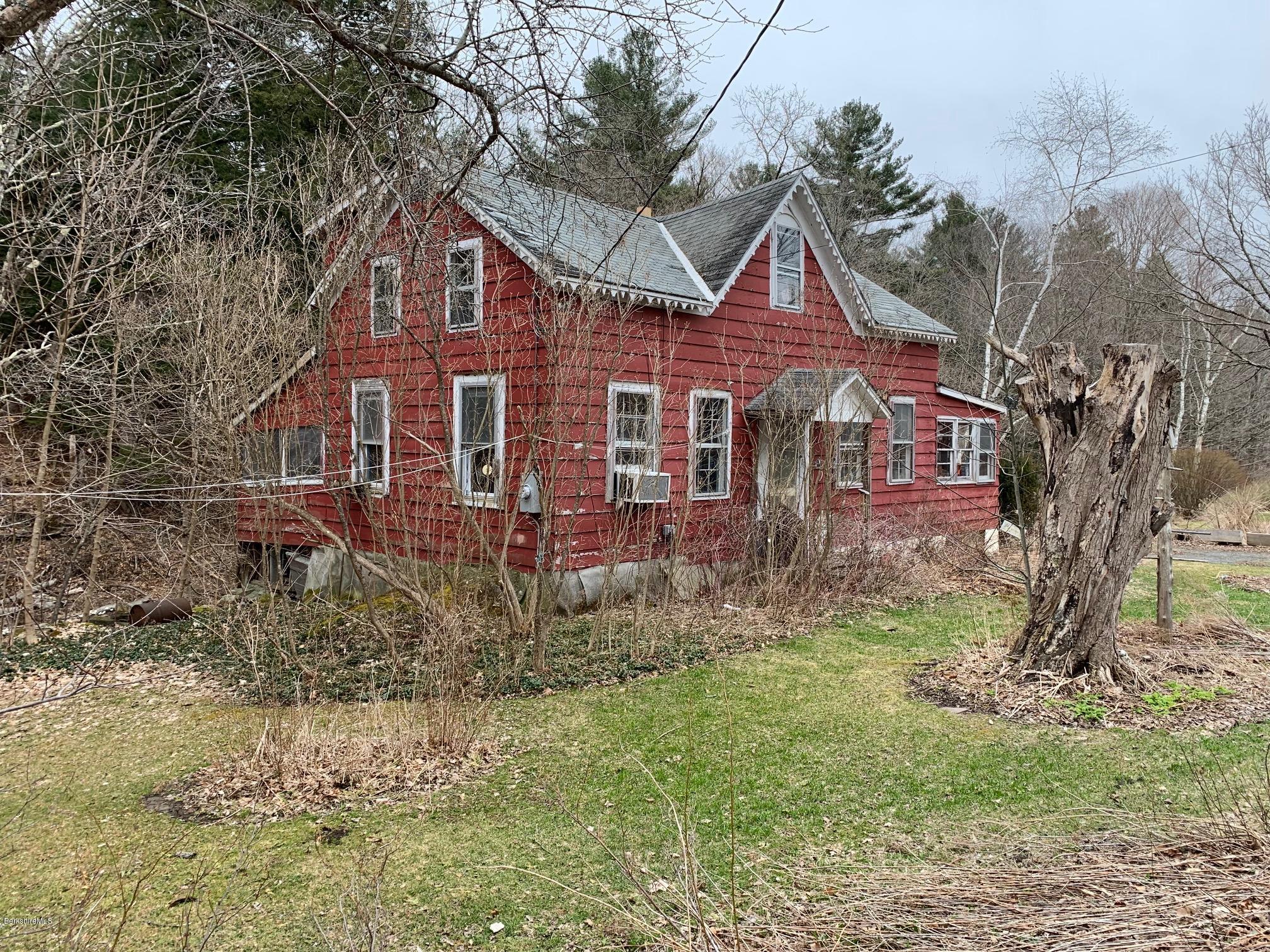 135 Main Road Tyringham, MA 01264 - Photo 3 of 8 a front view of a house with a yard