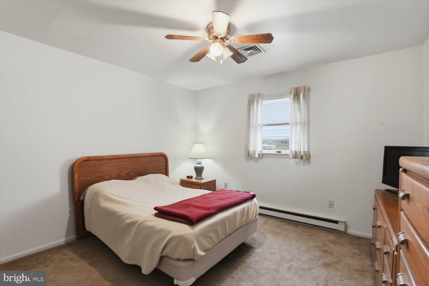 107 North Line Road Stevens, PA 17578 - Photo 11 of 26 a bedroom with a bed and a chandelier