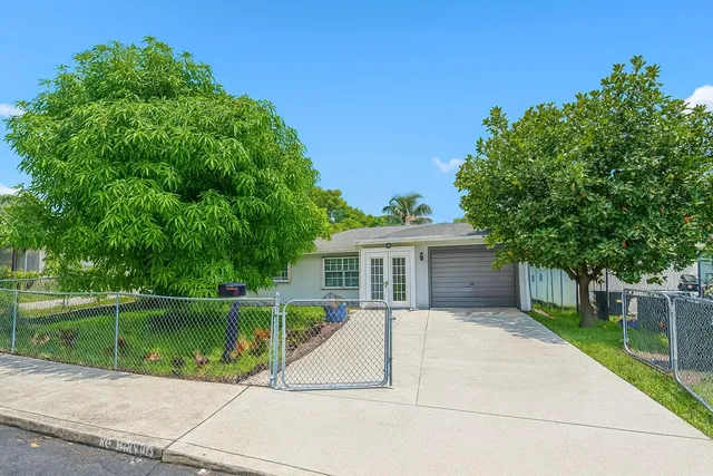 a view of a house with a backyard and a patio