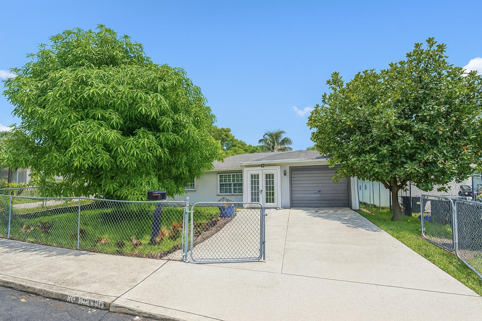 1733 Sunset Avenue Lake Worth Beach, FL 33460 - Photo 1 of 19 a view of a house with a backyard and a patio