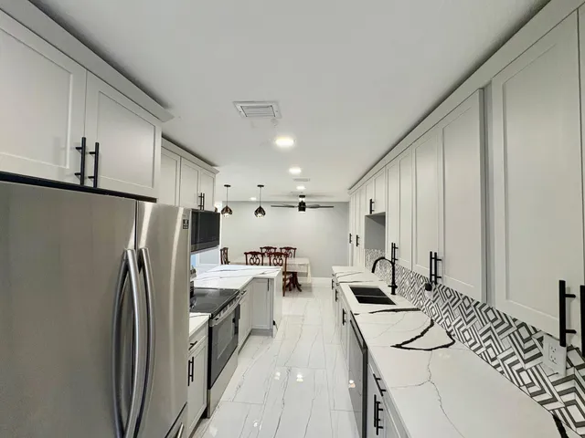 a kitchen with refrigerator and cabinets
