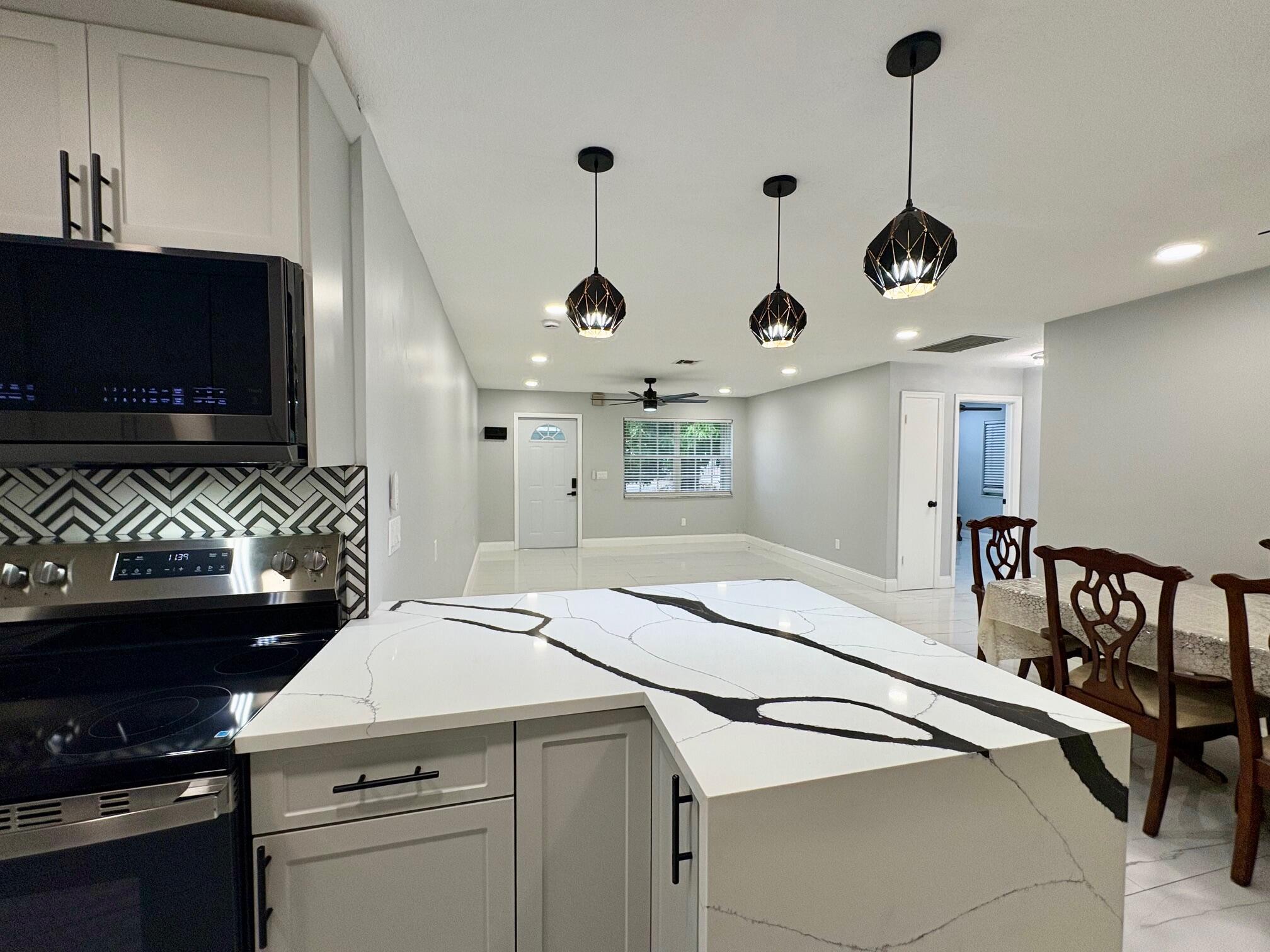 1733 Sunset Avenue Lake Worth Beach, FL 33460 - Photo 13 of 19 a very nice looking room with a flat screen tv