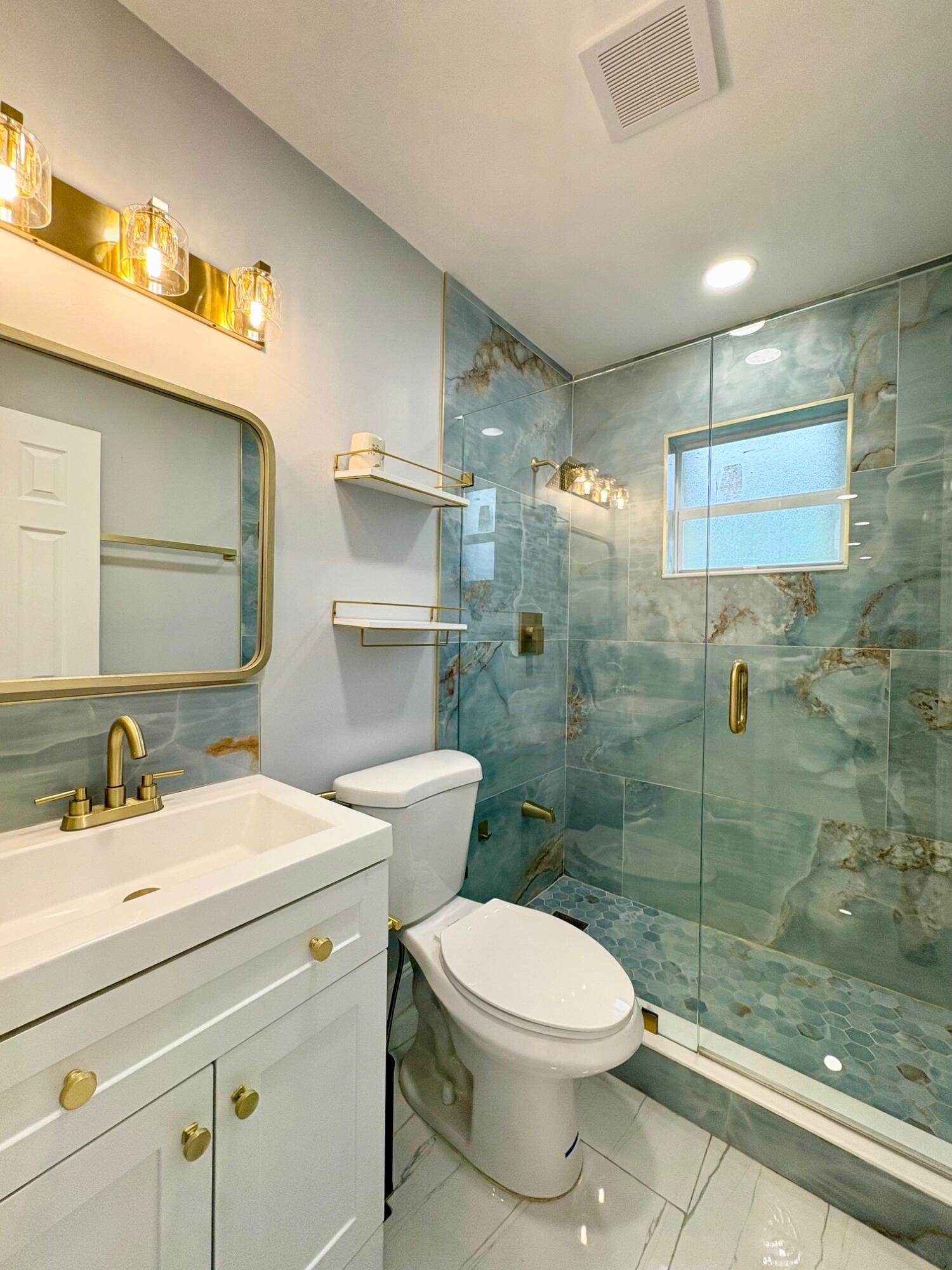 1733 Sunset Avenue Lake Worth Beach, FL 33460 - Photo 17 of 19 a bathroom with a sink a toilet and shower