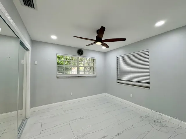 a view of a ceiling fan and a window