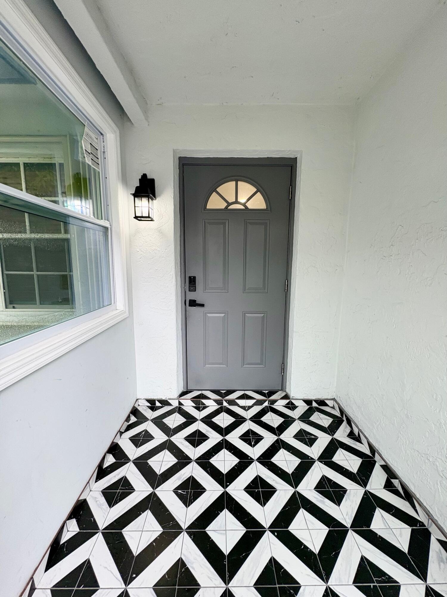 1733 Sunset Avenue Lake Worth Beach, FL 33460 - Photo 2 of 19 a bedroom with a bed and a window