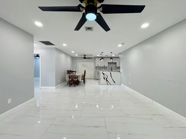 a view of a livingroom with furniture and a ceiling fan