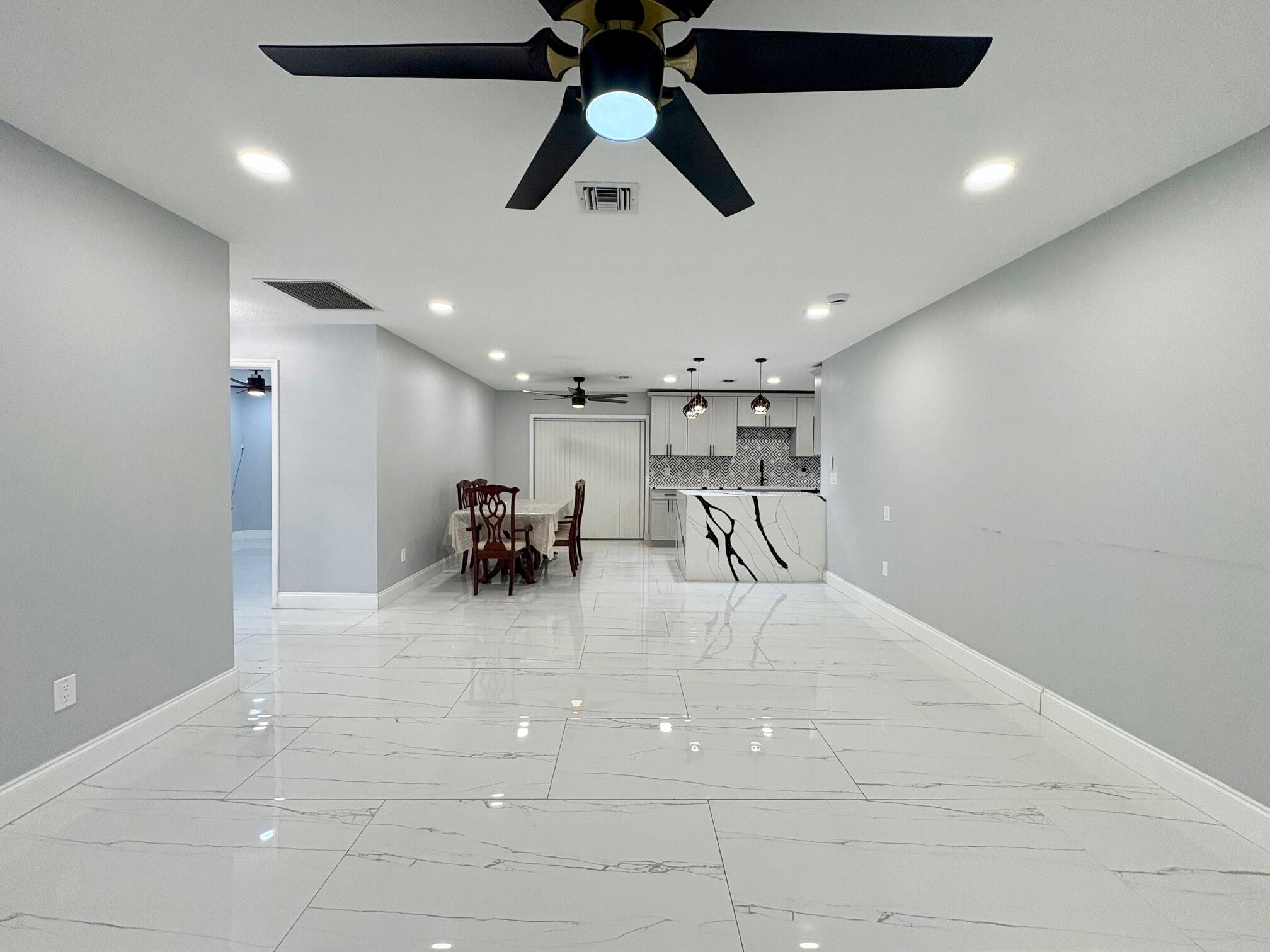1733 Sunset Avenue Lake Worth Beach, FL 33460 - Photo 3 of 19 a view of a livingroom with furniture and a ceiling fan