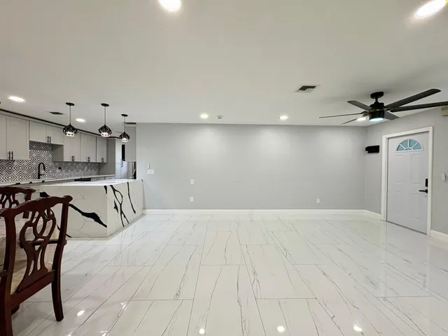 a view of a kitchen with a sink and cabinets
