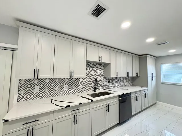 a kitchen with a sink stove and cabinets