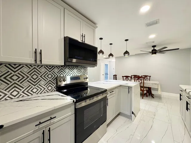 a kitchen with a sink and white cabinets