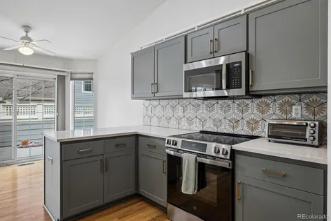 a kitchen with stainless steel appliances granite countertop a sink stove and microwave