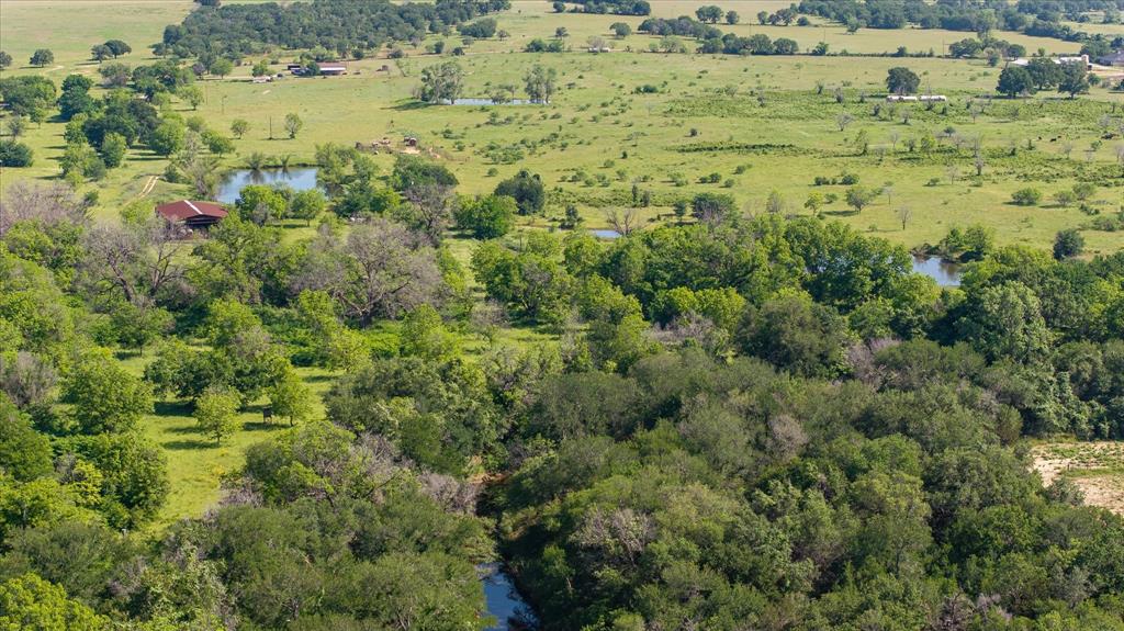 11701 Bowden Road Lipan, TX 76462 - Photo 17 of 26 an aerial view of residential houses with outdoor space and trees