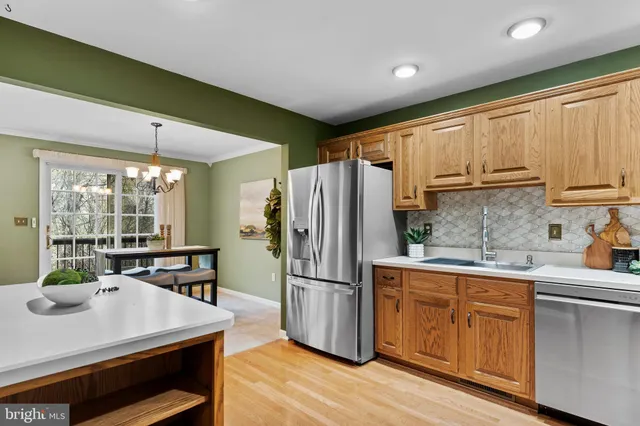 a kitchen with wooden cabinets and stainless steel appliances