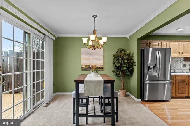 a dining room with furniture window and stainless steel appliances