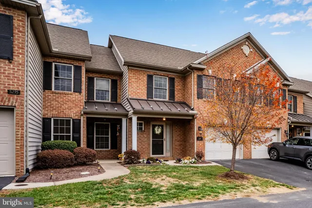a front view of a house with yard outdoor seating and garage