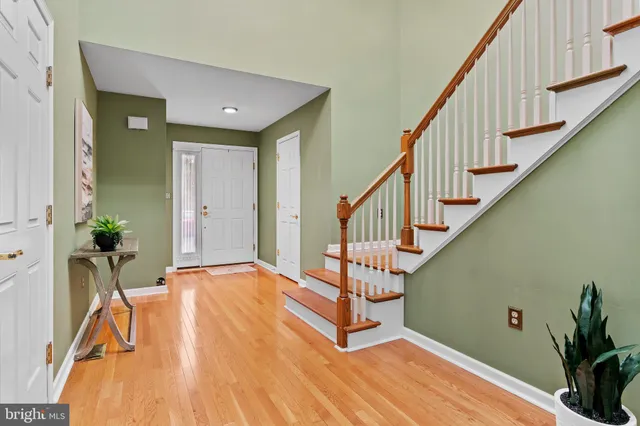 a view of entryway with wooden floor and stairs