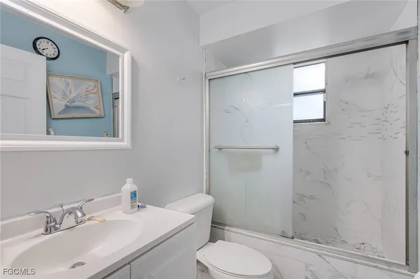 a bathroom with a sink toilet and shower