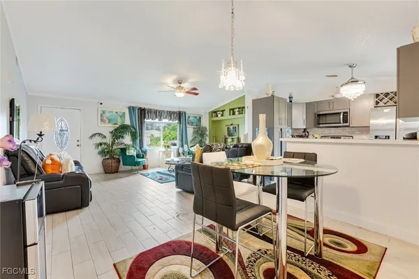 a living room with furniture a table and chairs