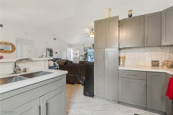 a kitchen with a sink refrigerator and cabinets