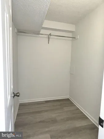 a bathroom with a granite countertop sink mirror and a shower