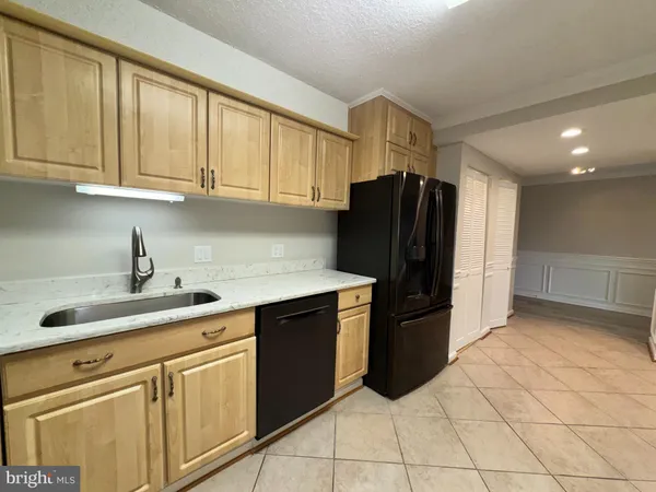 a view of an empty room with cabinet and mirror