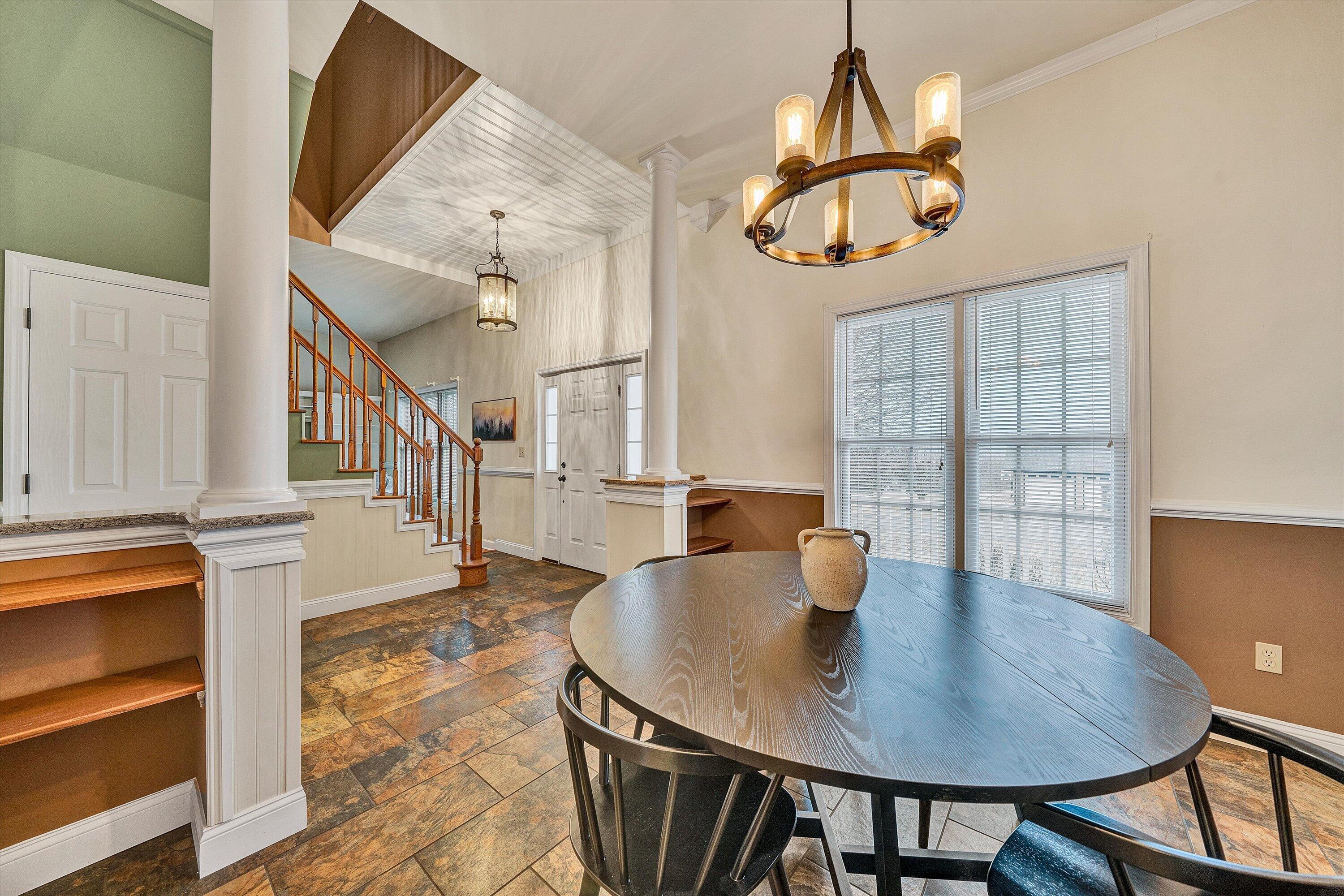 116 Dustys Road Covington, VA 24426 - Photo 12 of 96 a dining room with wooden floor a chandelier a wooden table and chairs