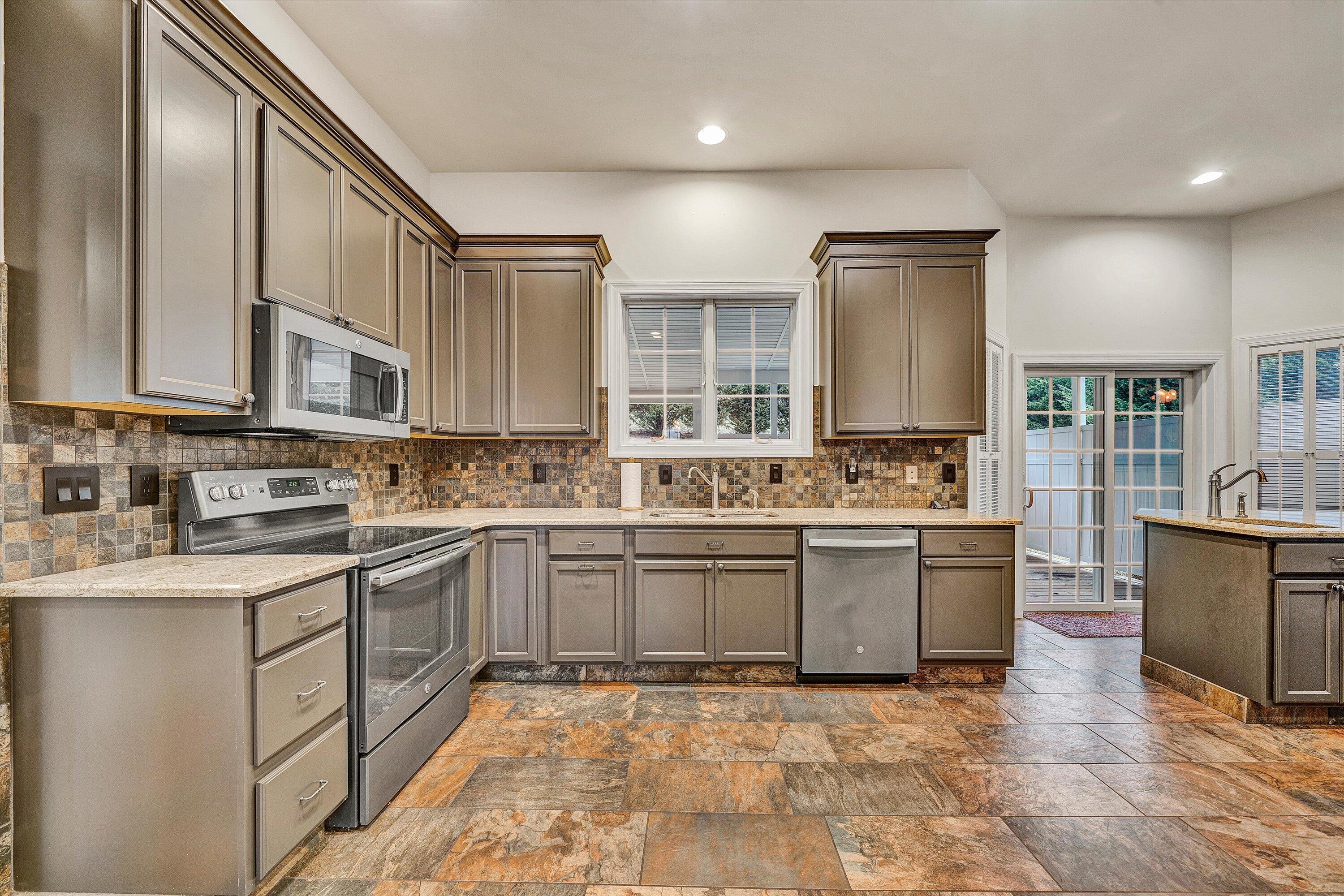 116 Dustys Road Covington, VA 24426 - Photo 19 of 96 a kitchen with stainless steel appliances granite countertop a stove top oven a sink a dining table and chairs