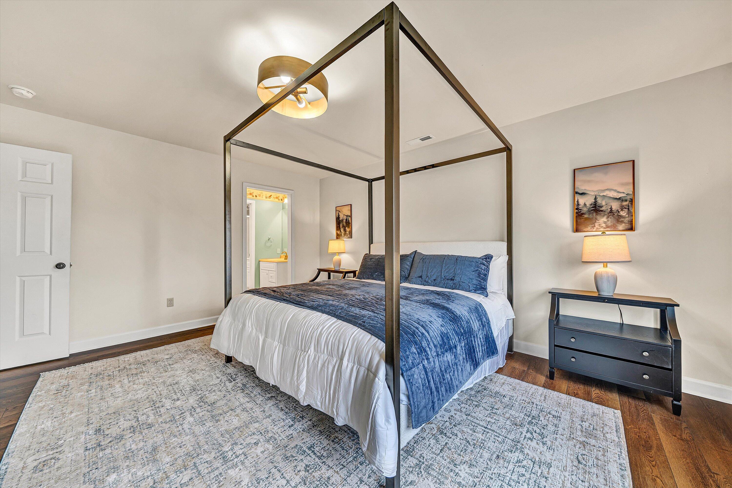 116 Dustys Road Covington, VA 24426 - Photo 50 of 96 a bedroom with a bed a dresser and a painting on the wall