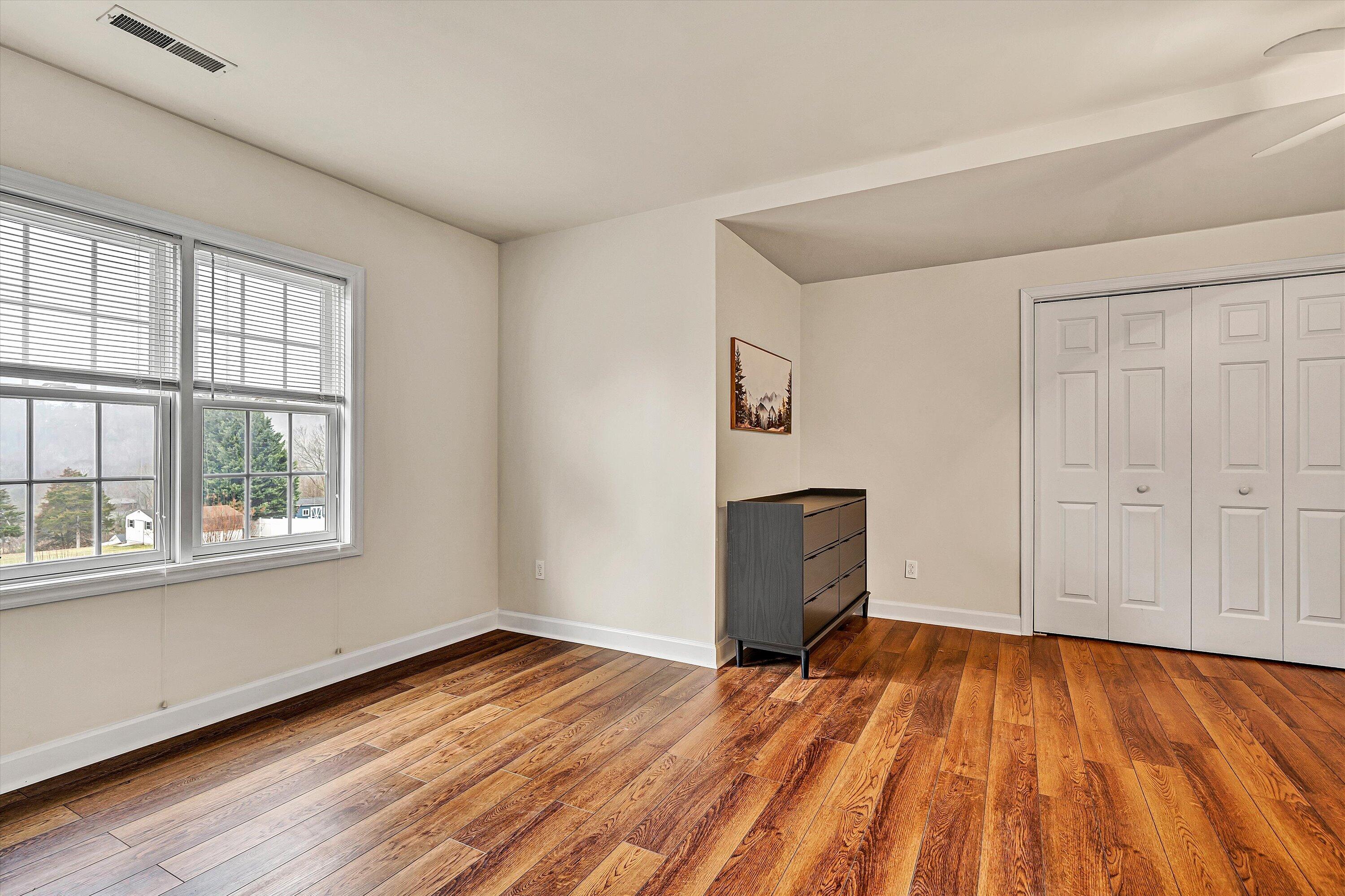 116 Dustys Road Covington, VA 24426 - Photo 60 of 96 a view of empty room with wooden floor and fan
