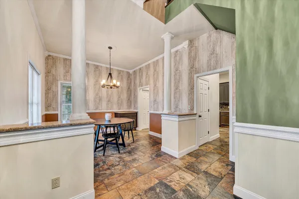 a view of a hallway with wooden floor and entryway