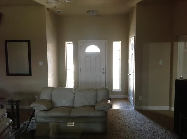 a living room with furniture and a lamp