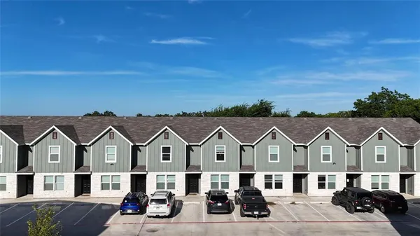 a front view of a house with a big yard