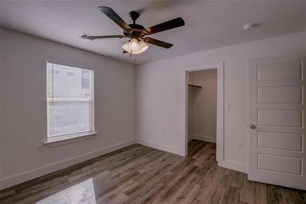 wooden floor in an empty room with a window
