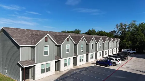 an aerial view of a house with a yard