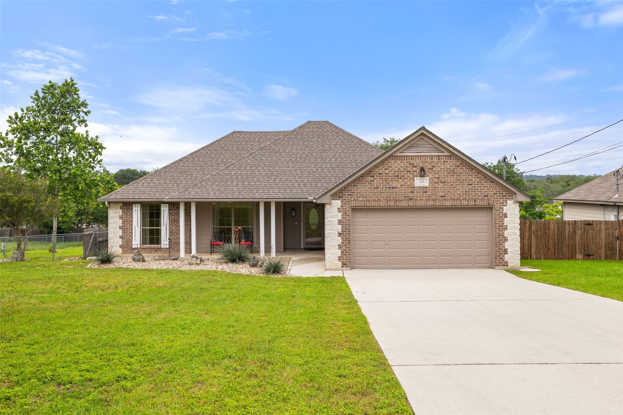 Front of house landscaped with 2 car garage
