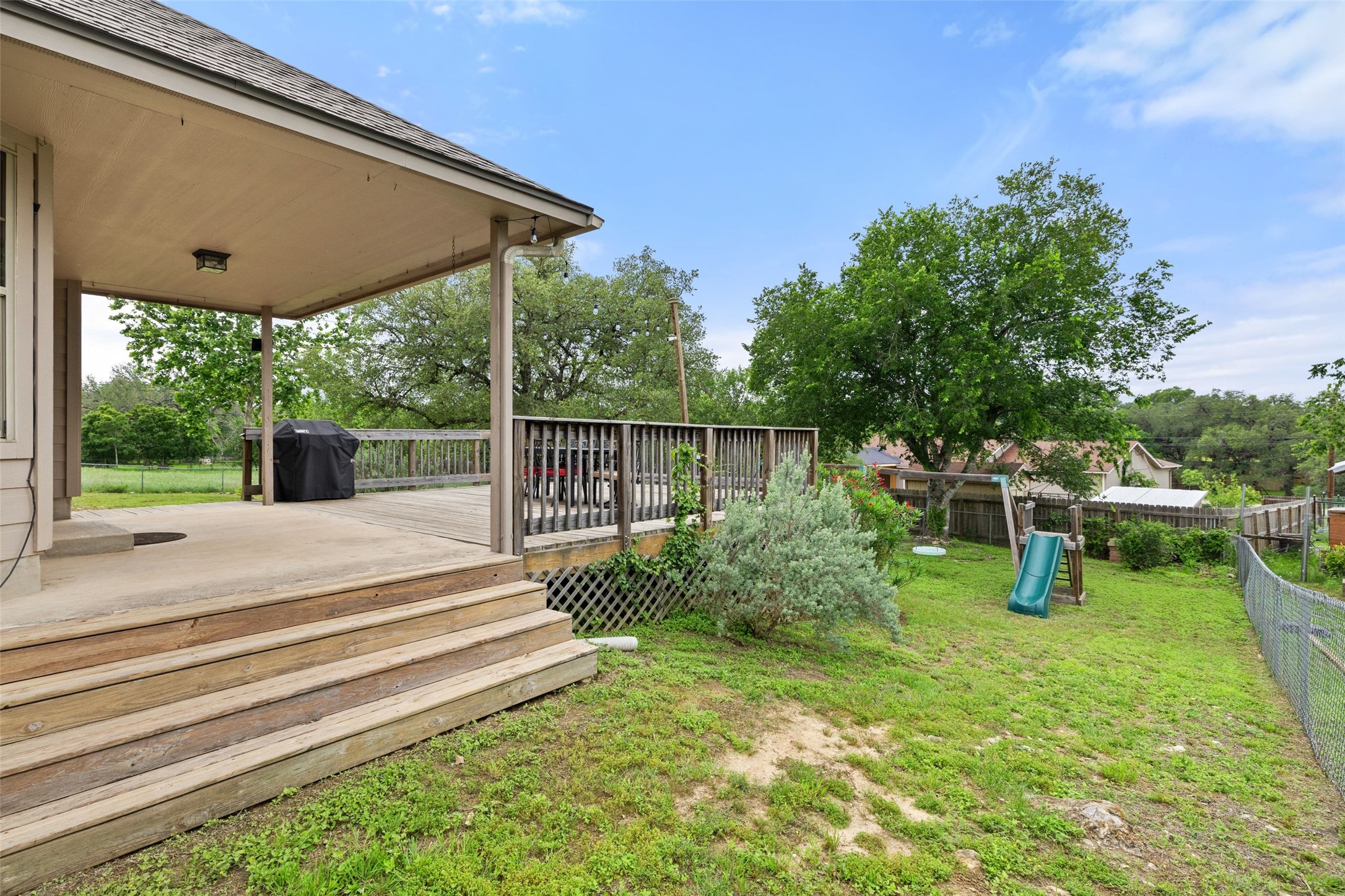 135 Barton Road San Marcos, TX 78666 - Photo 26 of 29 Beautifully landscaped backyard with access to an open patio deck