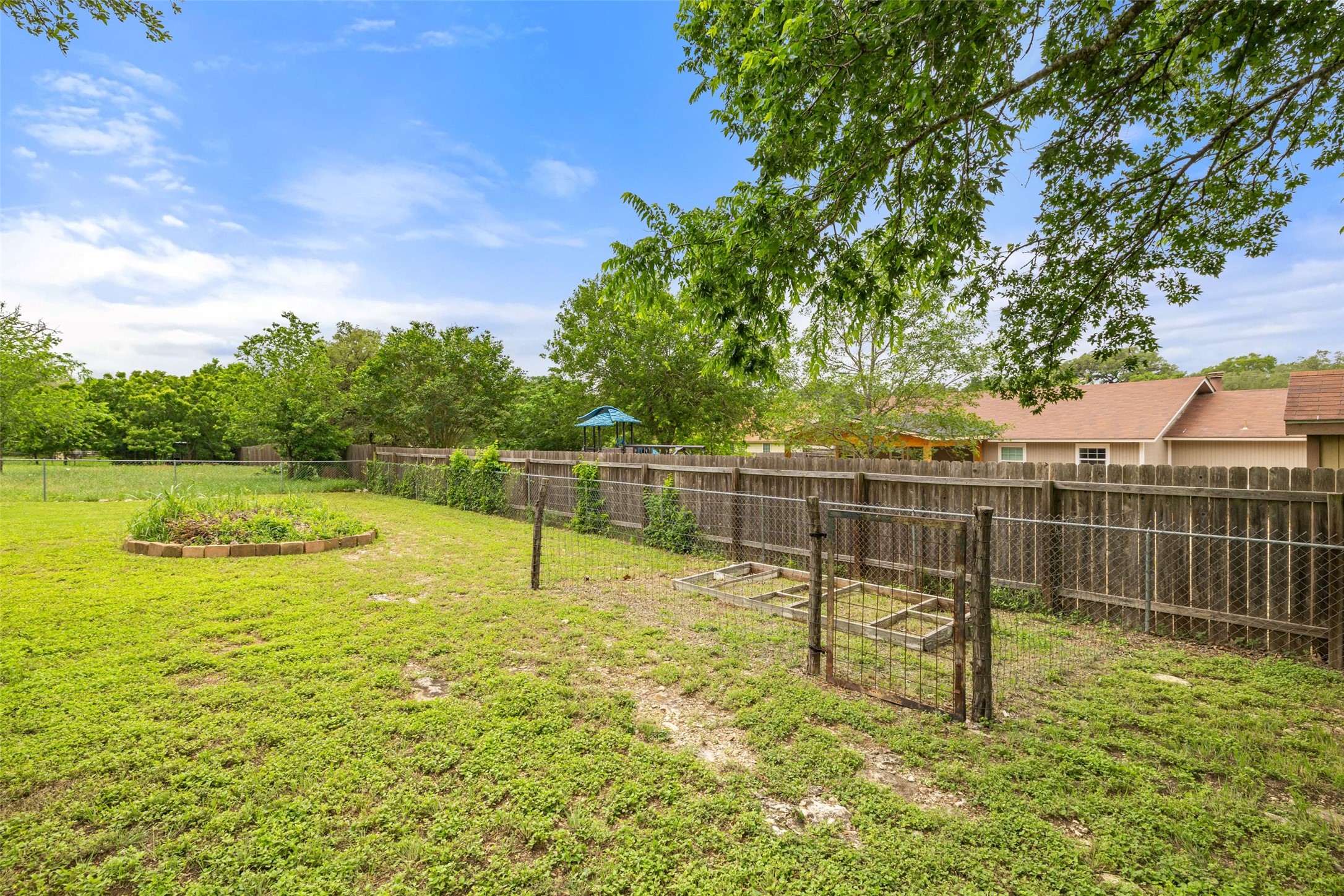 135 Barton Road San Marcos, TX 78666 - Photo 10 of 29 Spacious landscape backyard with a gardening area